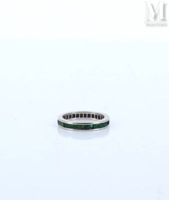 an image of a ring with a green stone in it