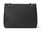 a black quilted shoulder bag with gold hardware