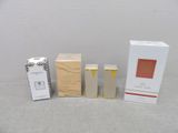 three boxes of perfume sitting next to each other on a table
