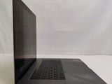 a laptop that is sitting on a white surface