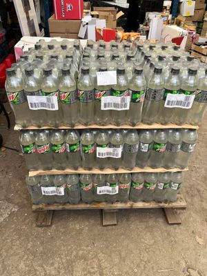 several bottles of water are stacked on a pallet in a warehouse
