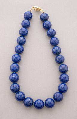 a blue beaded necklace with a gold clasp