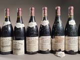 several bottles of wine are lined up on a table