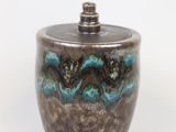 a close up of a ceramic jar with a lid