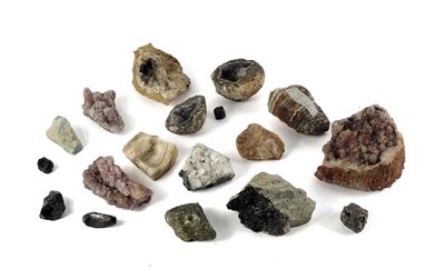 several different types of rocks and stones on a white surface