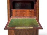 an old wooden desk with a green top and drawers