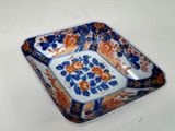 a blue and orange plate with a flower design on it