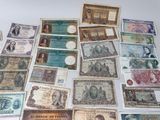 many different types of paper money laid out on a table