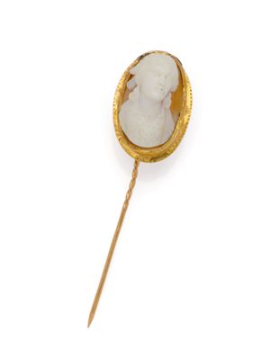 an image of a gold and white broochle on a stick