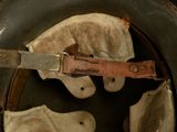 a close up of a helmet with a leather strap