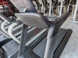 a row of tread machines in a gym room