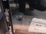 a man taking a picture of a cassette in a glass case