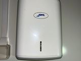a white paper towel dispenser next to a white towel dispenser