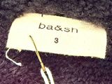 a label that says battsh on it next to a pair of scissors