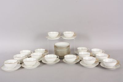 a lot of cups and saucers sitting on a table