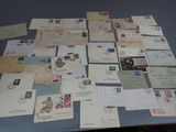 many different types of letters and envelopes laid out on a table