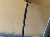 a sword that is standing up against a wall
