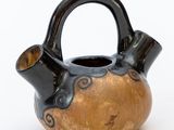 a black and gold vase with a handle on a white background