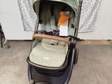 a baby stroller with a baby in it in a room