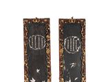 two pieces of black and gold painted wood with writing on them