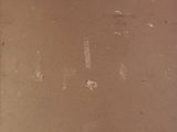 a brown suitcase with a label on it sitting on a table