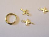 a close up of a ring and two charms on a table