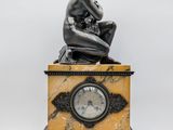 an image of a statue of a woman sitting on top of a clock