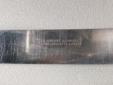 a knife that is on the wall with a name on it
