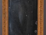 un miroir ancien en bois, avec un fond noir et un cadre doré