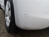 a close up of a car ' s front bumper with scratches