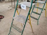 de nombreuses chaises et échelles dans une pièce où il y a beaucoup d'objets par terre