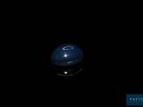 an image of a blue ball in the dark with a black background