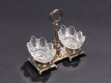 a silver plate with two glass dishes on it on a black surface