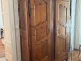 a large wooden cabinet in the corner of a room