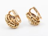 a pair of gold toned earrings with twisted wire and pearls