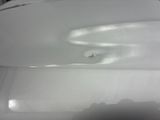 a white toilet with a hole in the middle of it