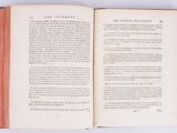an open book on a white surface with a red border