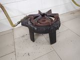 a small stove that is on the floor with a hose