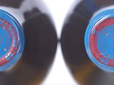 two bottles of beer sitting next to each other on a table
