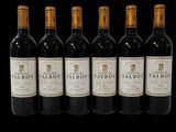 six bottles of red wine are lined up in a row