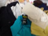 a pile of clothes on a shelf in a store