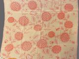 an orange and white handkerchief with flowers on it