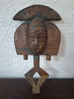 an image of a wooden sculpture of a man ' s head on a stand