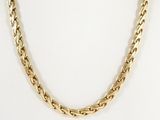 a close up of a gold chain necklace on a white background