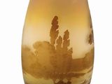 a yellow vase with a picture of a desert scene on it