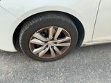 a white car with a flat tire on the street