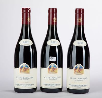 three bottles of red wine sitting next to each other on a table