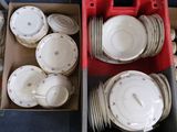a lot of plates and bowls in a red box
