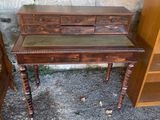 a wooden desk with a glass top and a shelf