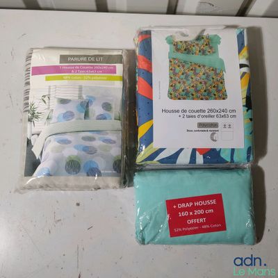 two sheets of bedding and a pillow on the table